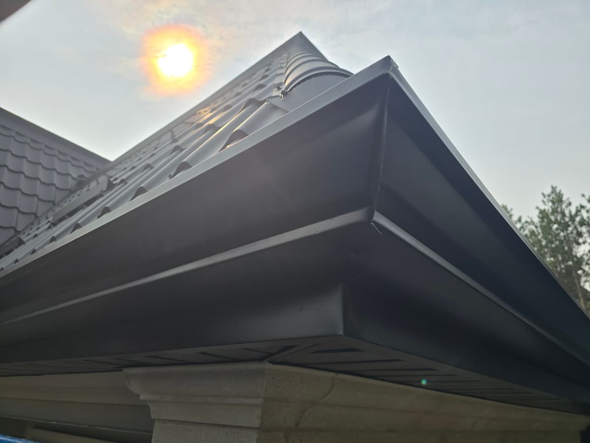 Clean seamless black eavestrough after North Aluminum install